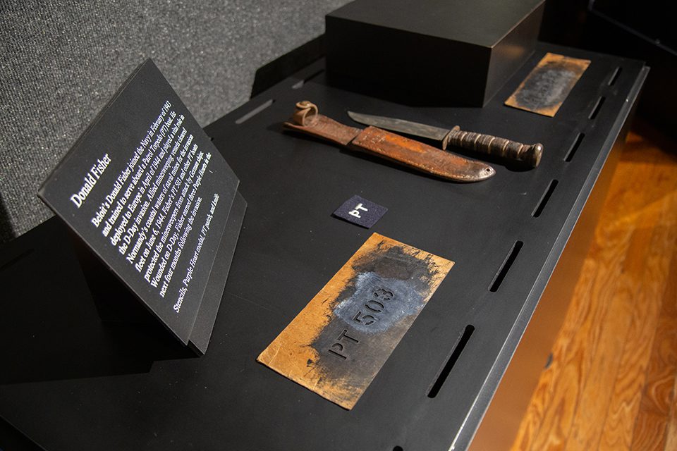 Donald Fisher of Beloit served in the US Navy aboard Patrol Torpedo (PT) boat 503 during the D-Day invasion. Shown are his knife, patch and stencils. WWII artifacts of metal stencils "PT-503" and a knife and sheath in D-Day exhibit.