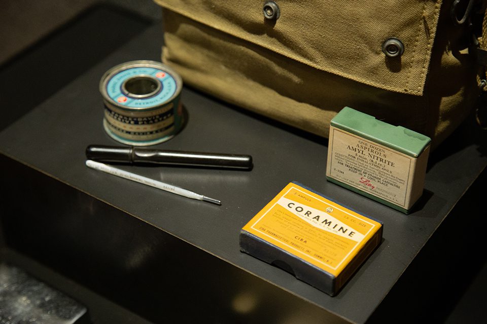 Contents of a medical kit belonging to Madison's Dr. John T. Mendenhall are on view. While serving in the 2nd Beach Battalion, Lieutenant Mendenhall participated in Operation Overlord and set up a hospital in a nearby French town. WWII Medical Kit - canvas bag, thermometer, box of Amyl Nitrate, box of Coramine, can of tape in D-Day exhibit.